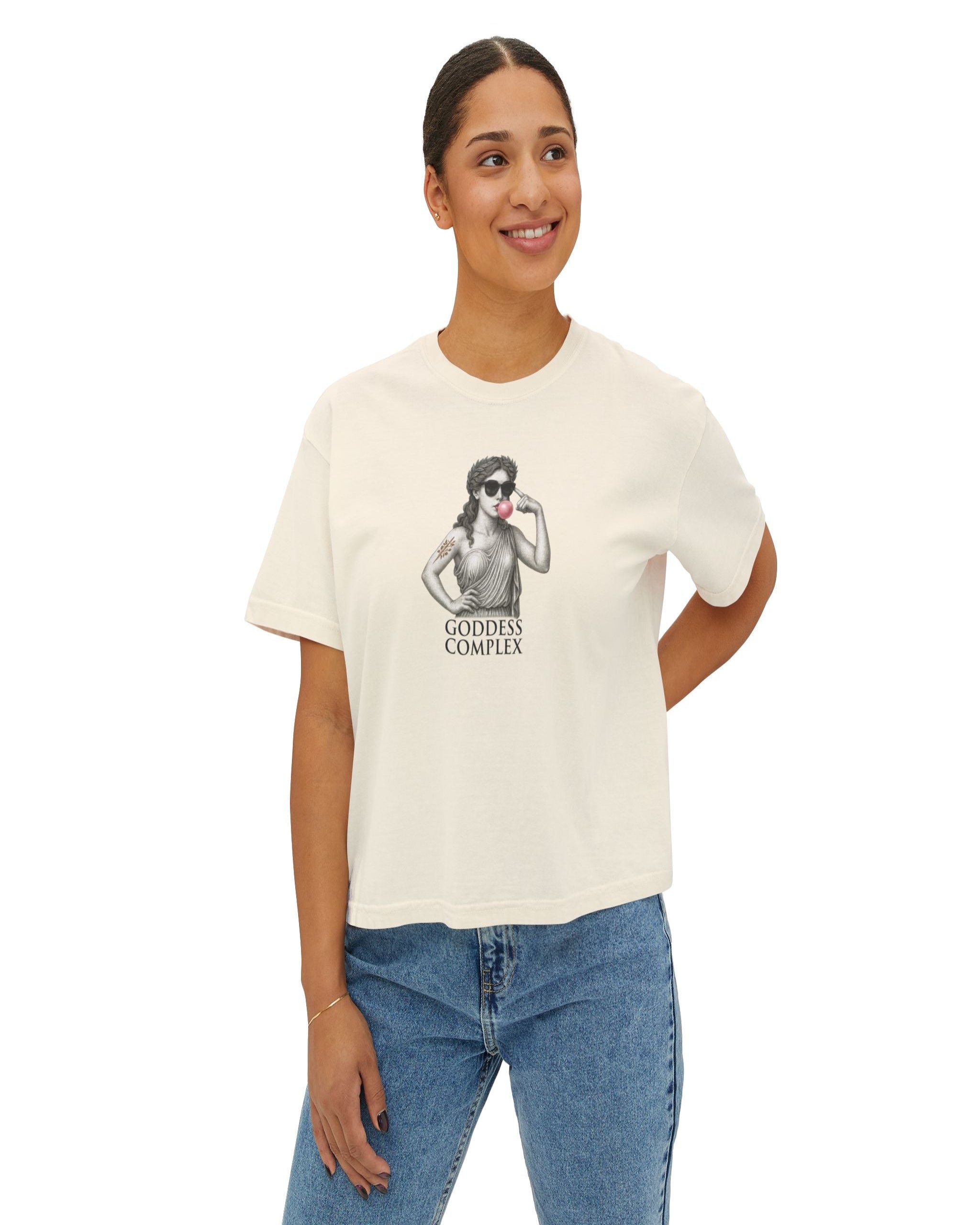 "Roman statue woman in sunglasses blowing bubblegum — printed on ivory boxy t-shirt with ‘Goddess Complex’ text"